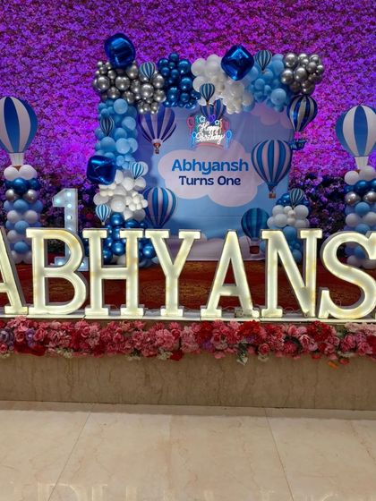 Large, illuminated marquee letters spelling out the birthday boy's name are a fantastic centerpiece for any stage setup. Here they are part of a Hot Air Balloon theme.