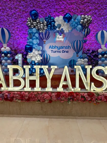 Large, illuminated marquee letters spelling out the birthday boy's name are a fantastic centerpiece for any stage setup. Here they are part of a Hot Air Balloon theme.