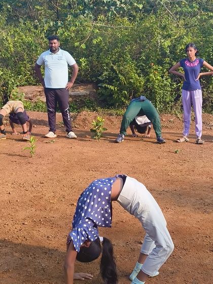 A young camper demonstrates a perfect backbend, showcasing the diverse talents and energy of our participants.
