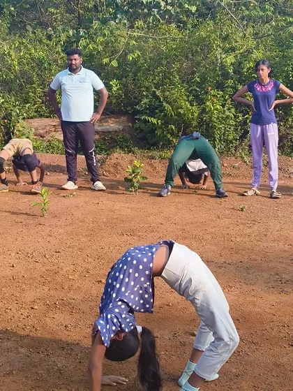 A young camper demonstrates a perfect backbend, showcasing the diverse talents and energy of our participants.