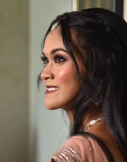 A side profile of a beautiful engagement look. The soft lighting highlights her features and the subtle smokey eye.