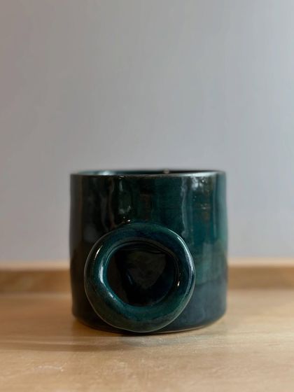 A single Forest Green mug with its distinctive ring handle. This design is both modern and comfortable to hold.