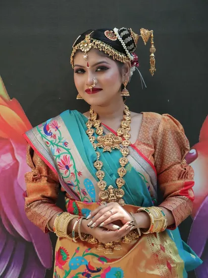 This shot captures the elegance of a South Indian bride against a vibrant backdrop. I guide my students on how to create makeup that complements both the outfit and the environment for stunning photography.