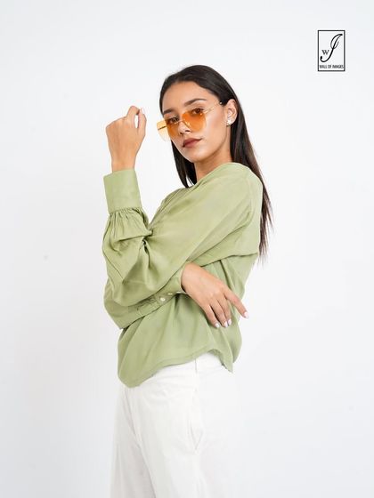 A three-quarter shot that gives a closer look at the sleeve details and the model's styling.