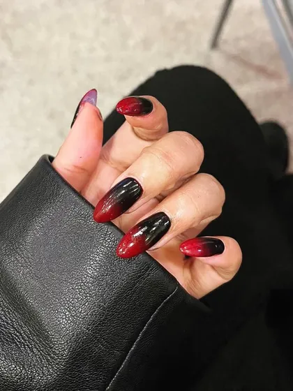 A dramatic red and black ombré on almond-shaped nails. This edgy, vampy look is perfect for making a bold statement.