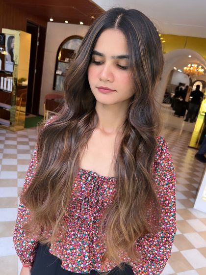 A gorgeous no-bleach balayage with a soft, seamless blend from dark roots to lighter ends. This is a great option for a gentle colour enhancement.