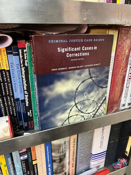 A book on significant cases in corrections. Understanding the criminal justice system requires delving into case briefs and academic work on topics like prison reform and racial justice.