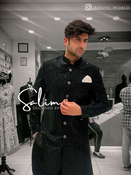 A sleek, modern Indo-Western jacket in a textured black fabric. The asymmetrical button placket gives it a contemporary feel, perfect for a cocktail party.