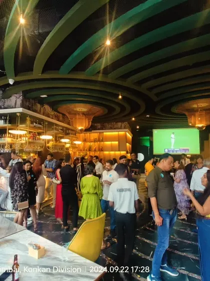 A wide view of one of our mixers in full swing. You can see people gathered in small groups, chatting naturally. This is what real-life social networking looks like.