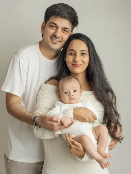 A classic family portrait with everyone looking at the camera. A perfect photo to announce your new arrival.