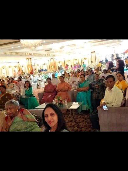 The family and friends at the 95th birthday event, watching the sand art performance with rapt attention.