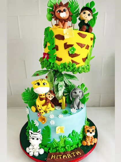 Welcome to the jungle! This gravity-defying cake was a joy to create for a little explorer's first birthday. Every animal is handcrafted from fondant, and the floating tier adds a touch of wild magic to the celebration.