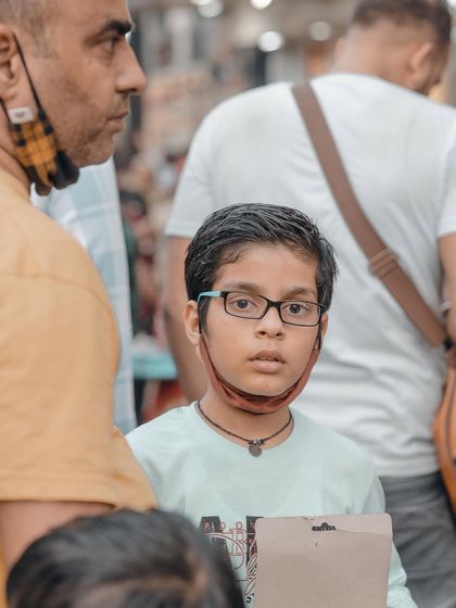 The curious and direct gaze of this young boy caught my attention. Kids often have the most honest expressions, making them great subjects for candid photography.
