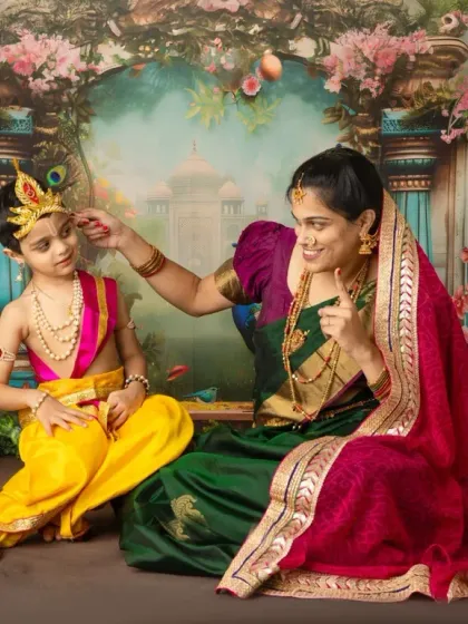 A mother gently adjusts the peacock feather on her little Krishna's crown. It is these small, tender gestures that tell the biggest stories of love.