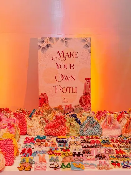 A "Make Your Own Potli" stall is a wonderful and interactive party favor idea. Guests get to customize their own traditional bags, creating a personal and memorable takeaway.