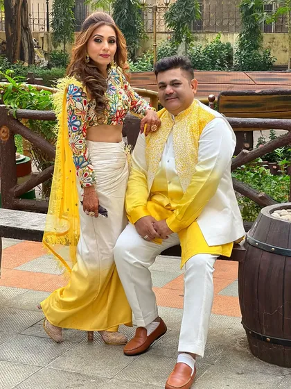 A beautiful portrait of the couple, coordinating in their festive yellow and white outfits.