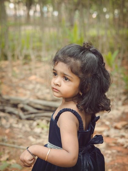 A candid, thoughtful expression captured in a beautiful natural setting. We look for these quiet moments during our outdoor kids' photography sessions.