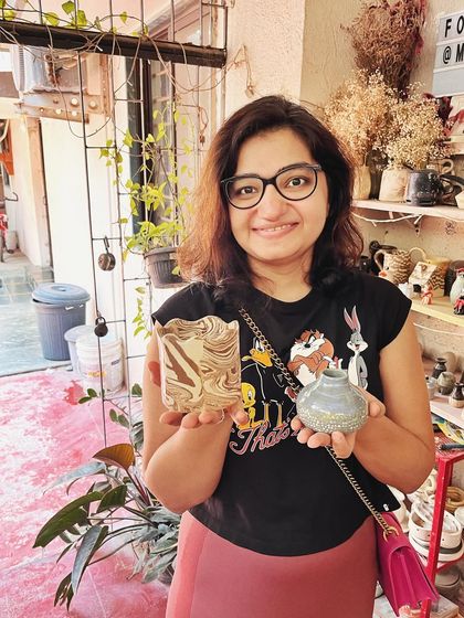 Look at these beautiful little wares from a beginner's course. She created a lovely marbled mug, a textured vase, and a carved luminary with a rich, rustic glaze.