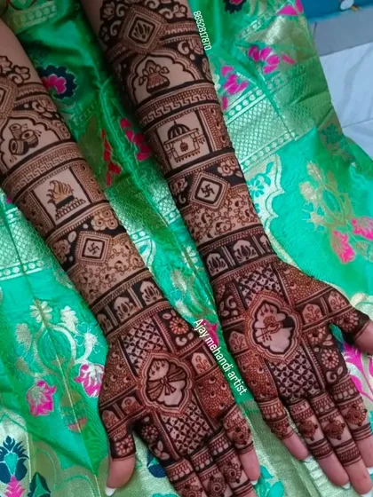 Full arm bridal mehndi with auspicious symbols like the swastika and kalash integrated into a beautiful geometric pattern.