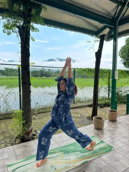 Moving into the High Lunge, or Crescent Lunge, pose. This asana strengthens the legs and opens the chest, and practicing it with a view of the mountains makes it even more powerful.