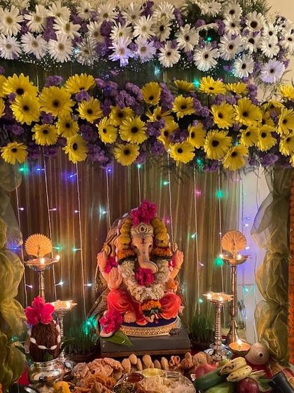 This decoration uses a combination of yellow sunflowers and purple daisies to create a unique color palette. The fairy lights woven through the flowers add a magical sparkle to the mandap.