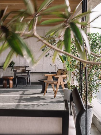 The sea-facing deck is a sanctuary in the urban rush of Mumbai, blending tactile materials like Kota stone with natural greenery.