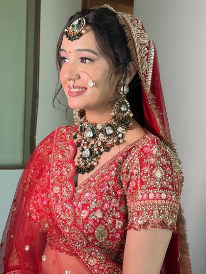 Dolling up Pratiksha was a heartwarming experience. I chose a soft, minimal look with delicate touches of pink and a subtle shimmer to bring out her natural radiance against her classic red lehenga.