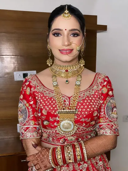 Mansi's bridal look was a beautiful blend of traditional and modern. We paired a classic red lehenga with a soft smokey eye and a glowing base.