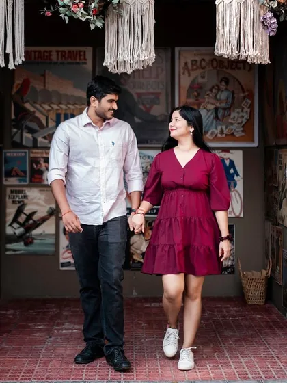 Walking out of a quirky, vintage-themed shop. This photo tells a story and captures a slice of life, making the pre-wedding shoot feel personal and unique.