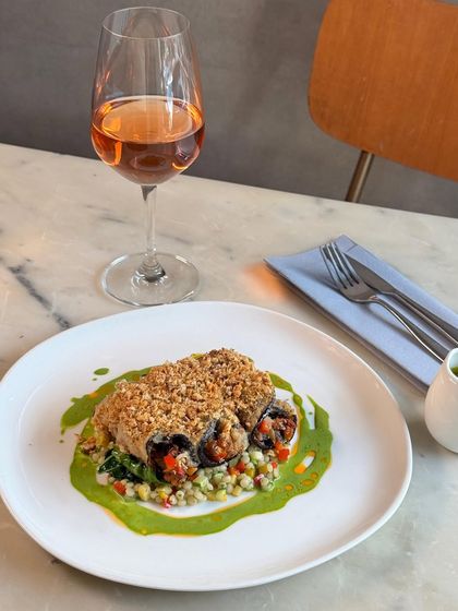 New on the menu is our Eggplant Rollatini. Tender eggplant is filled with a Mediterranean vegetable caponata, baked with cheese, and served over pearl couscous with a vibrant sauce verdure.