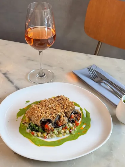A vegetarian delight, our new Eggplant Rollatini. It's filled with a Mediterranean vegetable caponata and served over pearl couscous with a vibrant sauce verdure.