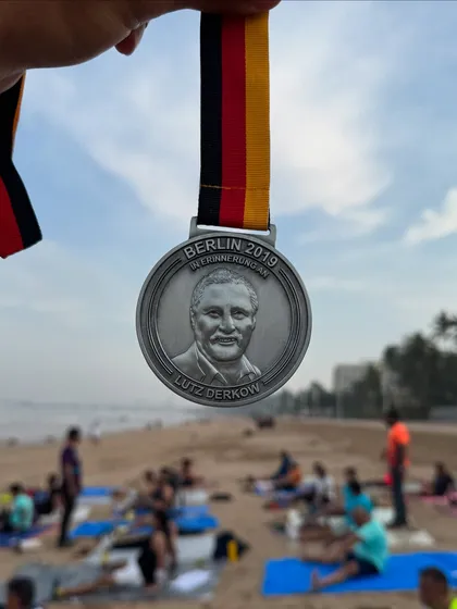 The Berlin Marathon medal from 2019. Running this fast, flat course is a dream for many marathoners, and we provide the training to help you get there.