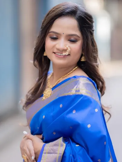 A close-up of the engagement look, showing the soft eye makeup and the traditional Maharashtrian nath. Her skin looks dewy and fresh.