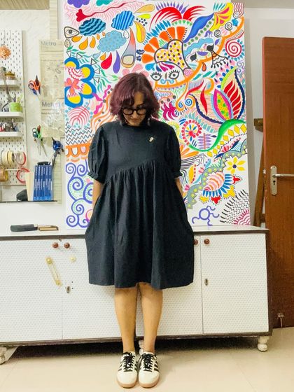 The beautiful contrast between a simple black dress and the explosion of color in my painting. Art and fashion are always influencing each other in my world.