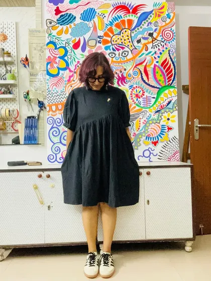The beautiful contrast between a simple black dress and the explosion of color in my painting. Art and fashion are always influencing each other in my world.