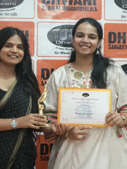 A teacher congratulates an adult student on her award.