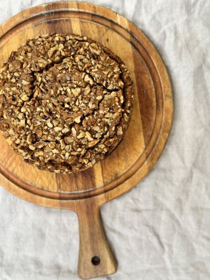 Our whole carrot cake, topped with a generous amount of crunchy walnuts.
