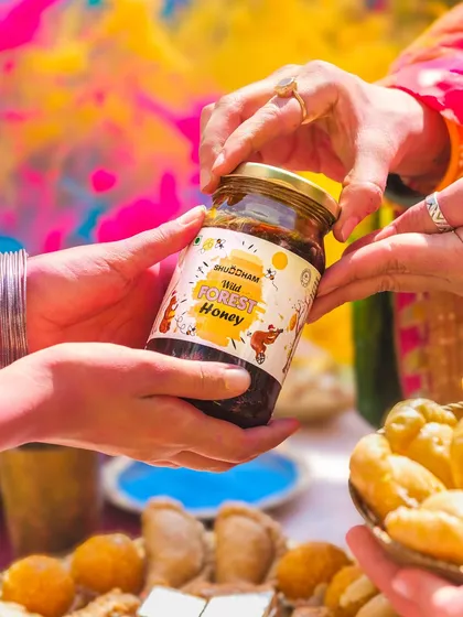 This image captures the act of sharing, a central theme in festivals. The focus is on the product being gifted, set against a colorful, joyful background.