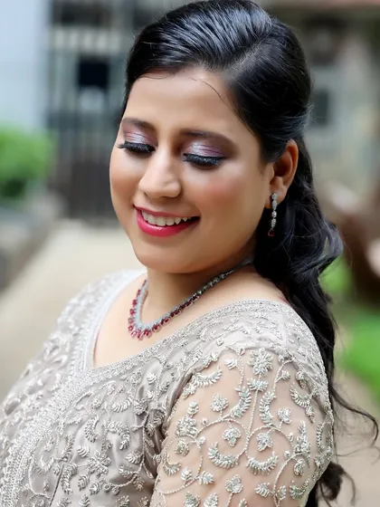 A close-up of the "glass finish" makeup on my client. The skin looks luminous and healthy, with a soft pink eyeshadow and matching lip.
