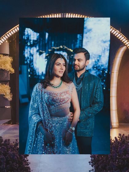 A creative shot of the couple framed within a screen, showcasing the high-tech and personalized elements of the event design.