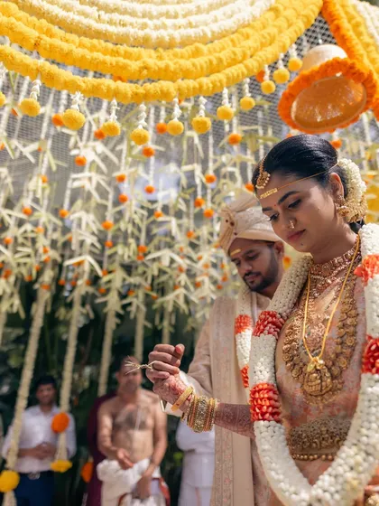I specialize in bringing traditional ceremonies to life, like this beautiful South Indian wedding. The mandap is intricately decorated with strings of jasmine and marigolds, creating a sacred and visually stunning space for the couple's vows.