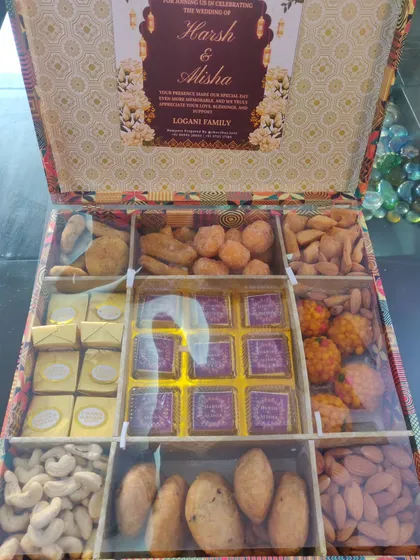 For Indian weddings, the 'bhaji' or 'sagan' box is a cherished tradition. I curated over 130 of these magnificent wedding boxes, each filled with a wholesome mix of dry fruits, traditional sweets like laddoos, and my signature handmade chocolates. This shows my capability to handle large, customized orders for wedding celebrations.