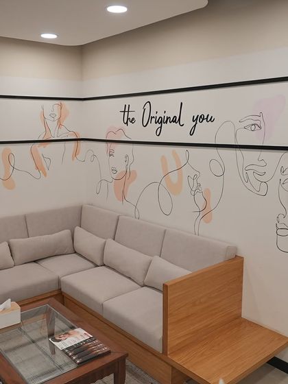 The comfortable seating area in our Lajpat Nagar clinic, featuring our "the Original you" wall art.