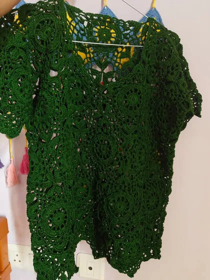 Another look at the green lace top, showing how the light passes through the openwork design. It’s a piece that feels both substantial and incredibly airy.