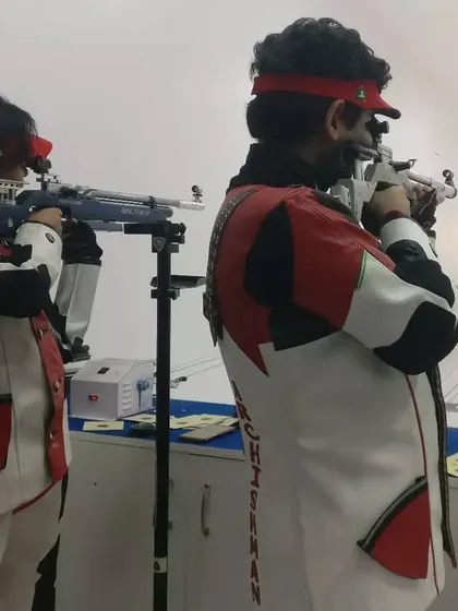 Shooters Shreya Sharma and Archishman Pandey in perfect sync during a 10m Air Rifle training session. The image captures the intense focus required in precision shooting.