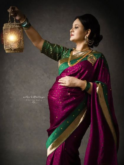 A self-portrait from my own maternity journey in a traditional Paithani saree. Holding a lantern, this pose has a classic, old-world charm.