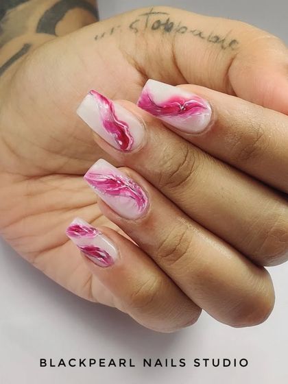 A beautiful example of marble nail art using soft gel extensions. The delicate pink and white swirls create a sophisticated and eye-catching look that mimics natural stone.