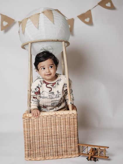 Up, up, and away. Our hot air balloon basket prop is a client favorite for creating adorable and imaginative photos.
