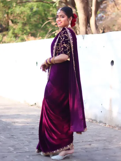 A full-length side view, showing the flow and elegance of the velvet saree.