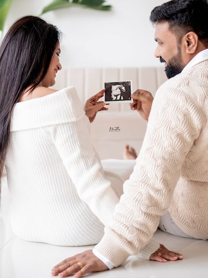 The first family photo. Holding up the ultrasound scan is a beautiful way to include your little one in the maternity shoot before they even arrive.